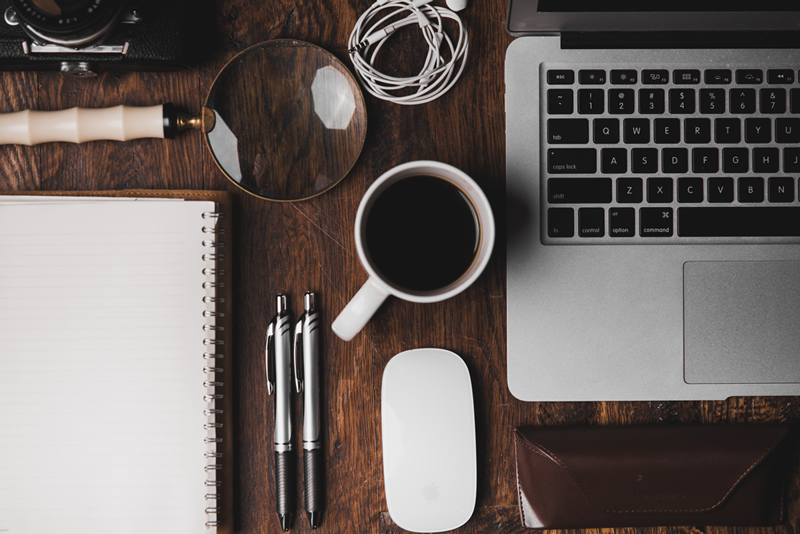 Cofee and MacBook on a wooden desk